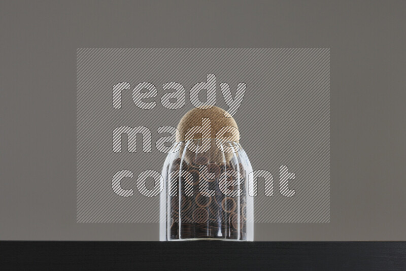 Buttons in a glass jar on black background