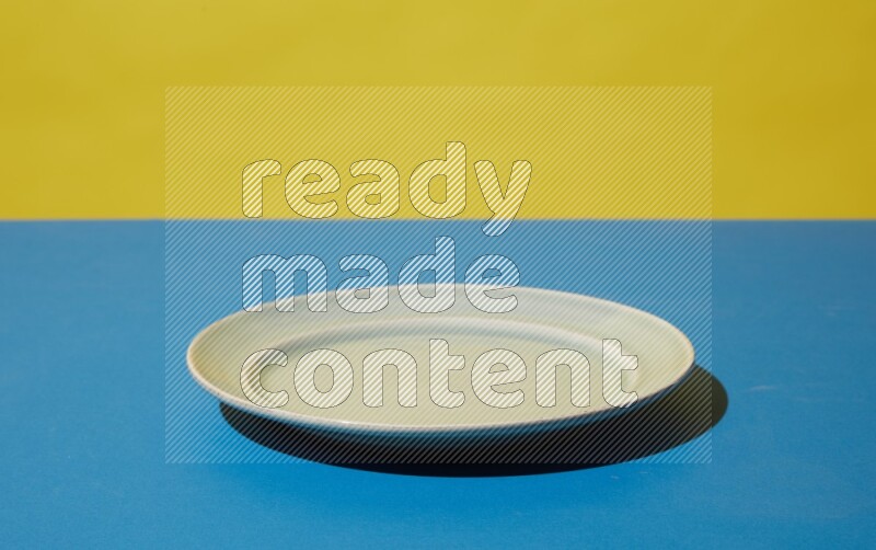 white plate on yellow and blue background