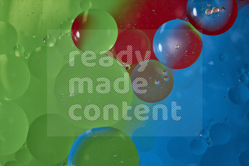Close-ups of abstract oil bubbles on water surface in shades of blue, red and green