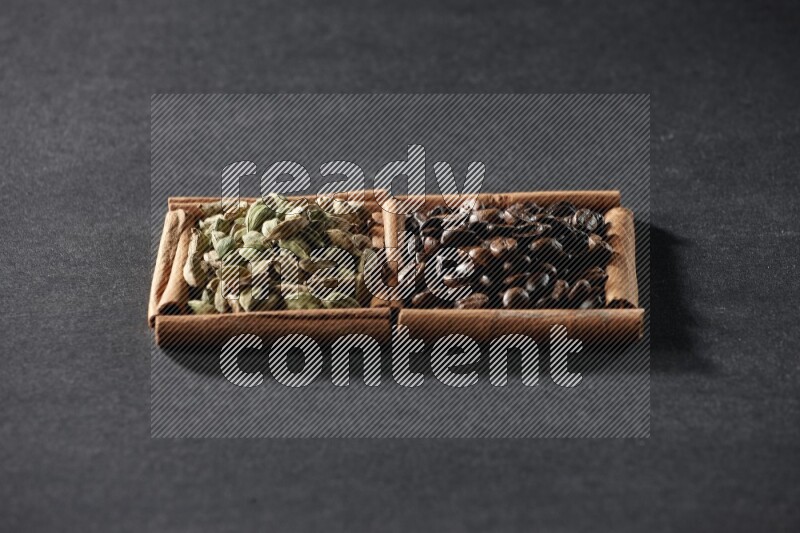 2 squares of cinnamon sticks full of coffee beans and cardamom on black flooring