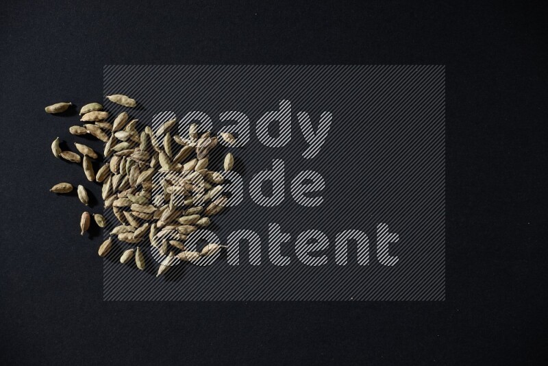 Cardamom seeds on black flooring