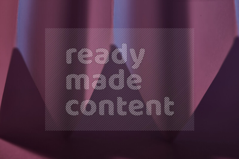 A close-up abstract image showing sharp geometric paper folds in purple gradients