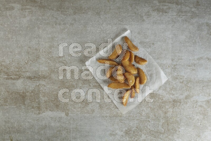 wedges potato on parchment paper on grey textured counter top
