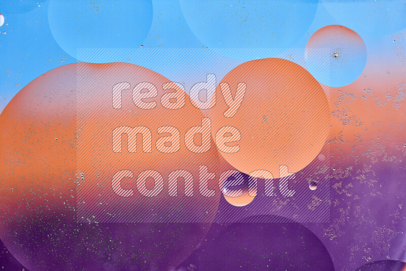 Close-ups of abstract oil bubbles on water surface in shades of blue, orange and purple