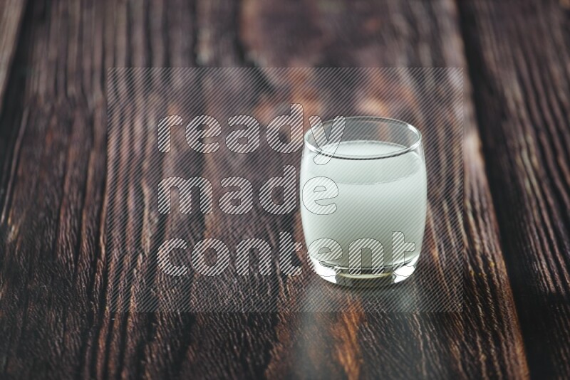 Cold drinks in a glass cup such as water, tamarind, qamar eldin, sobia, milk and hibiscus on wooden background