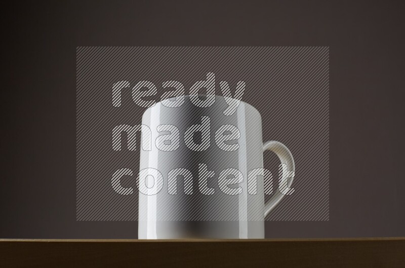 Low angle shot of a white cup on grey background