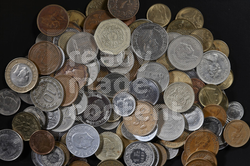 A close-ups of random old coins on black background