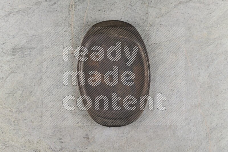 A vintage metal tray on grey marble background