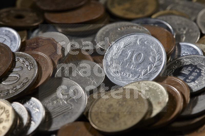A close-ups of random old coins on black background