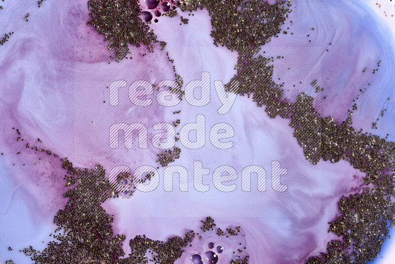 A close-up of sparkling gold glitter scattered on swirling blue and red background