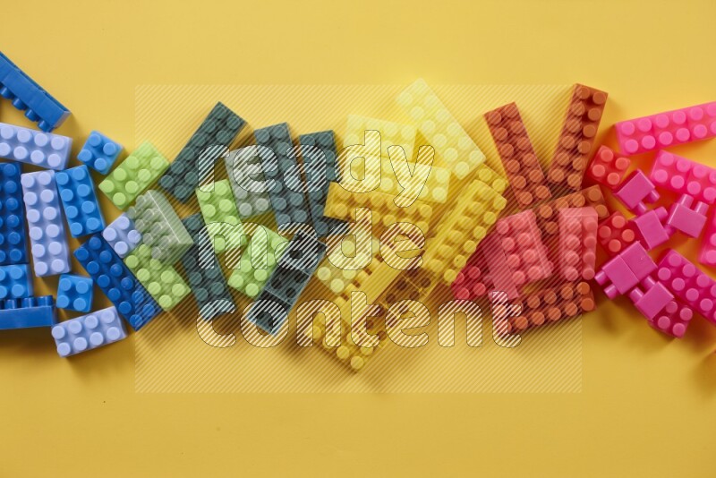 Multicolored plastic building blocks on different backgrounds (kids toys)