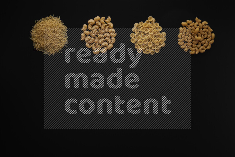 Different pasta types in 4 bunches on black background