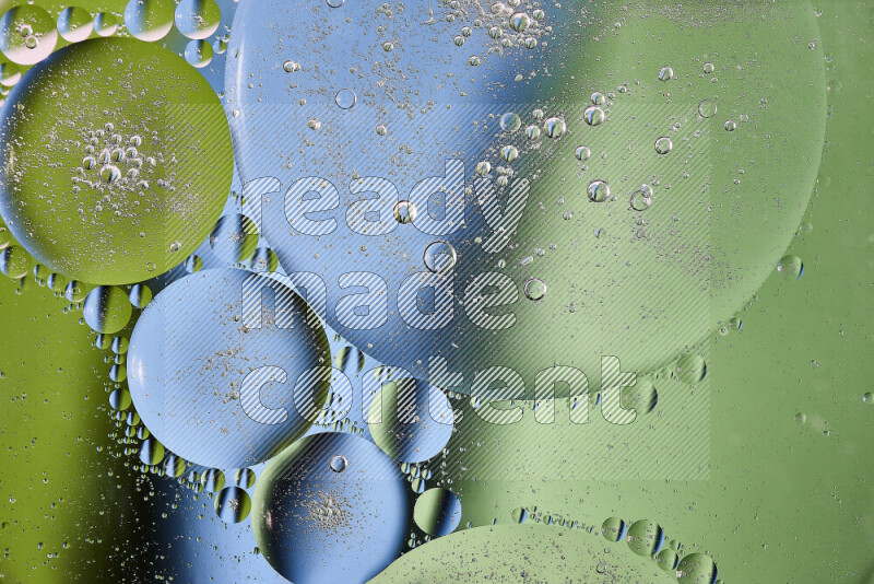 Close-ups of abstract oil bubbles on water surface in shades of green and blue