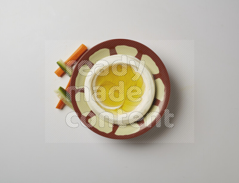 Lebnah garnished with olive oil in a traditional plate on a white background