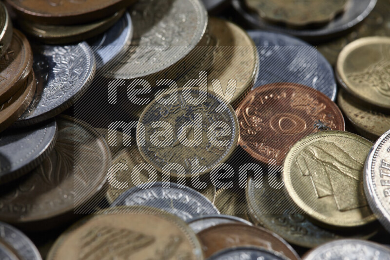 A close-ups of random old coins on black background