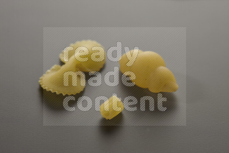 Different pasta types on grey background