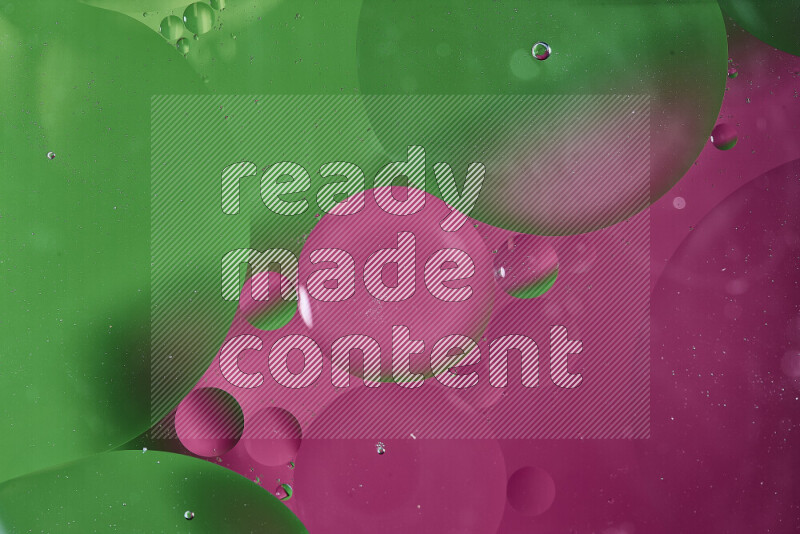 Close-ups of abstract oil bubbles on water surface in shades of green and pink