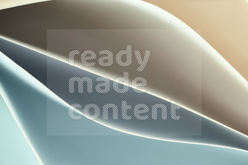 This image showcases an abstract paper art composition with paper curves in green and orange gradients created by colored light