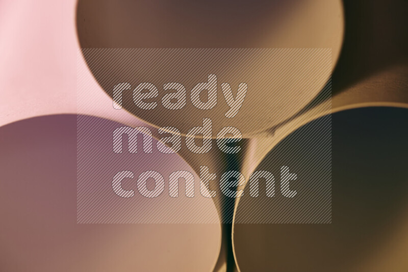 The image shows an abstract paper art with circular shapes in varying shades of pink and warm tones