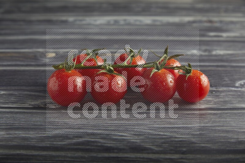Red cherry tomato vein on a textured grey wooden background 45 degree