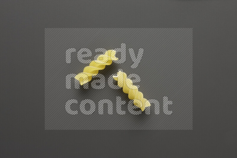 Fusilli pasta on grey background