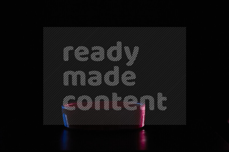 Potteries with colored rim light against black background