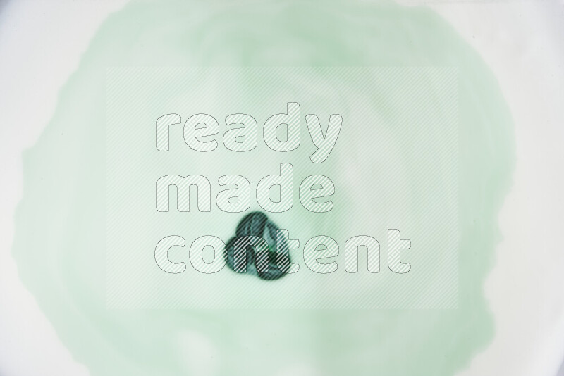 A close-up of abstract swirling patterns in green gradients