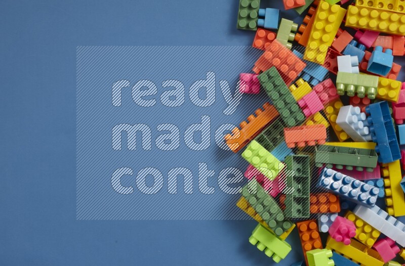 Multicolored plastic building blocks on different backgrounds (kids toys)