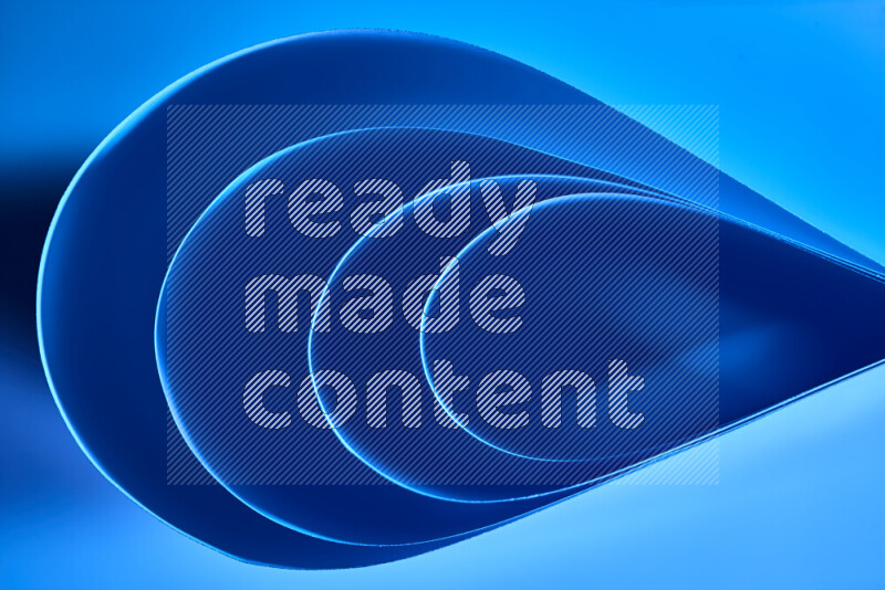 An abstract art of paper folded into smooth curves in blue gradients