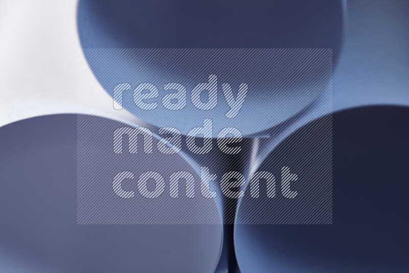 The image shows an abstract paper art with circular shapes in varying shades of blue