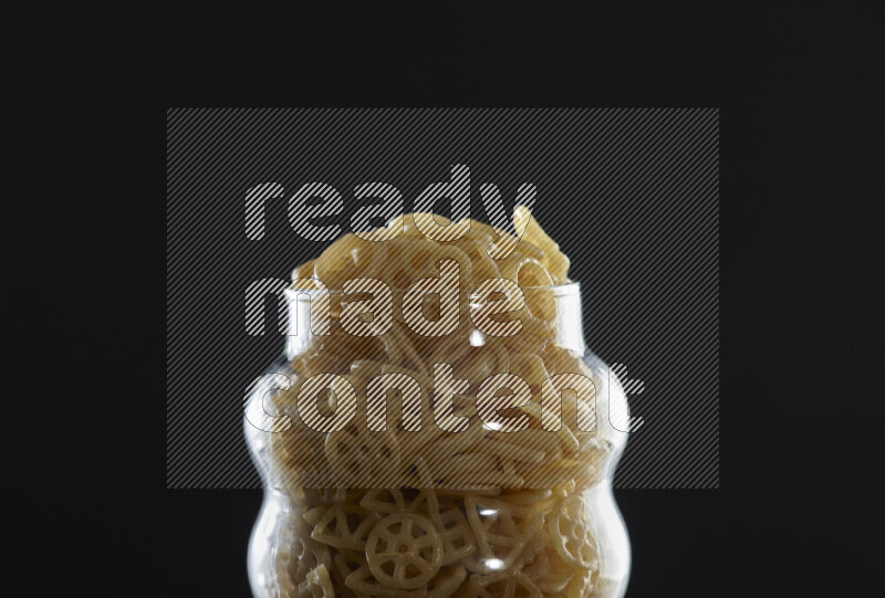 Snacks in a glass jar on black background