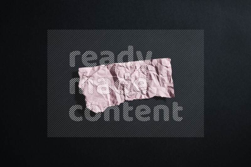 Pink paper sheet on black background