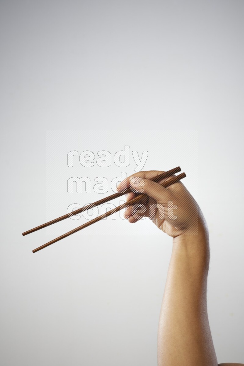 Male Hand Holding Chop Stick on white background
