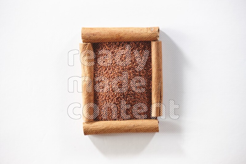A single square of cinnamon sticks full of garden cress on white flooring