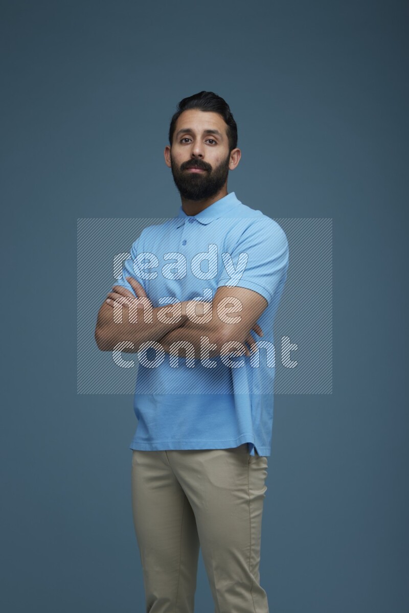 Man posing in a blue background wearing a Blue shirt