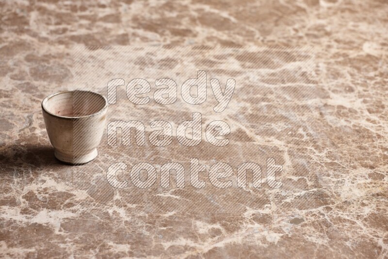 Pottery Cup on Beige Marble Flooring