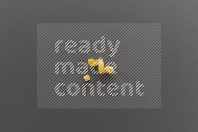 Small rings pasta with other types of pasta on grey background