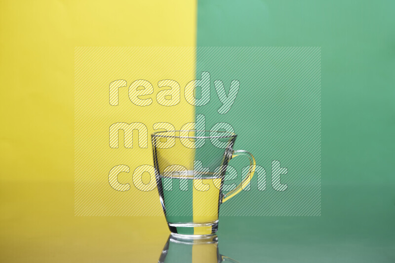 The image features a clear glassware filled with water, set against yellow and green background