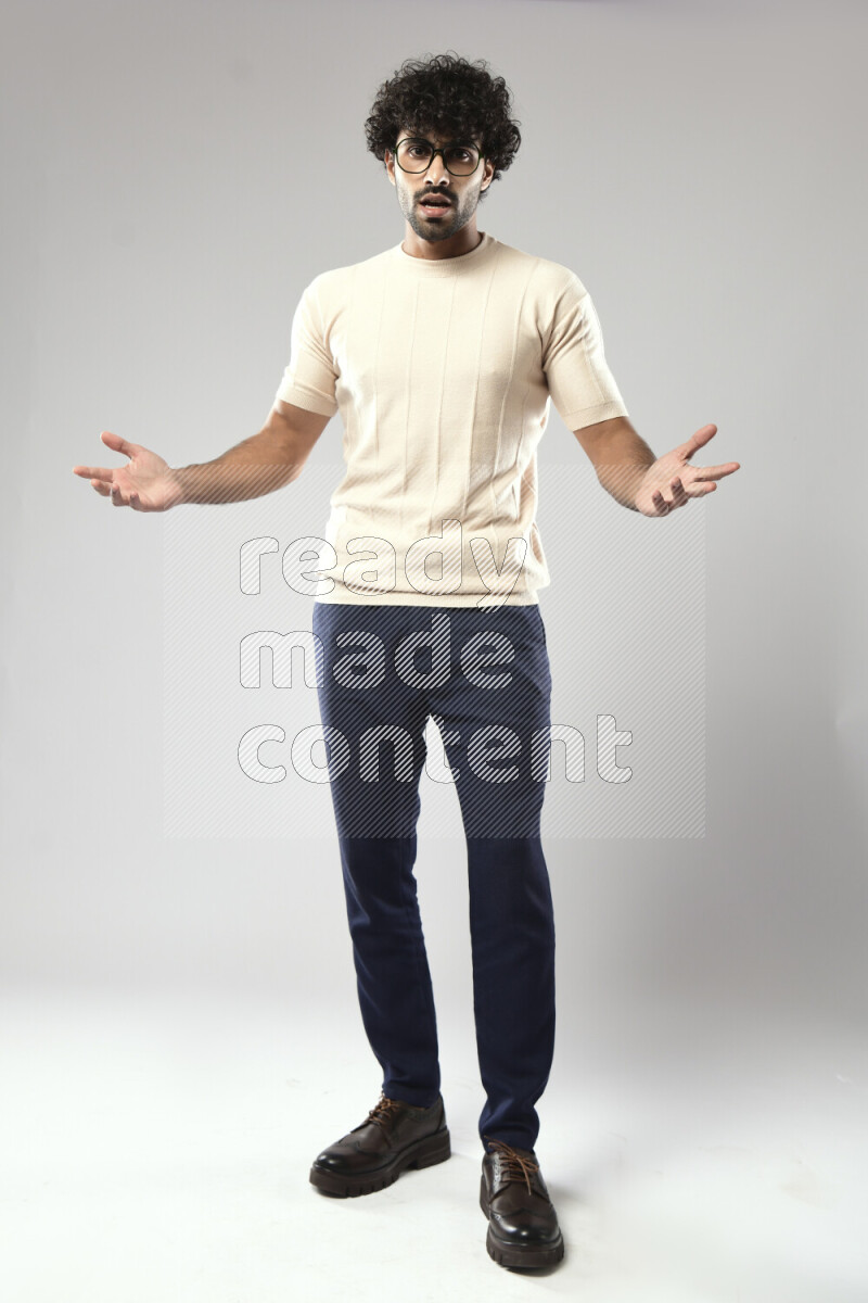 A man wearing casual standing and making a hand gesture on white background