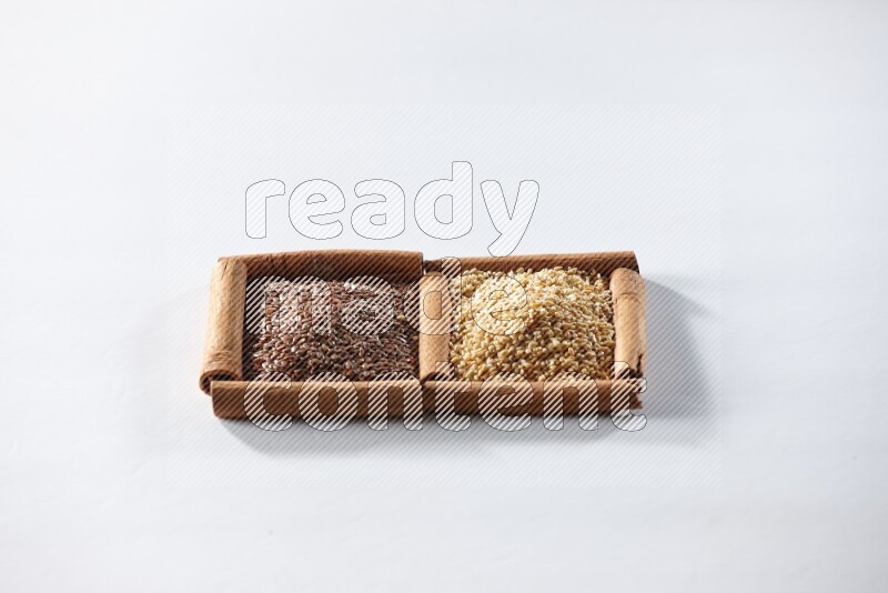 2 squares of cinnamon sticks full of flaxseeds and sesame on white flooring