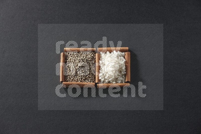 2 squares of cinnamon sticks full of white pepper and salt on black flooring
