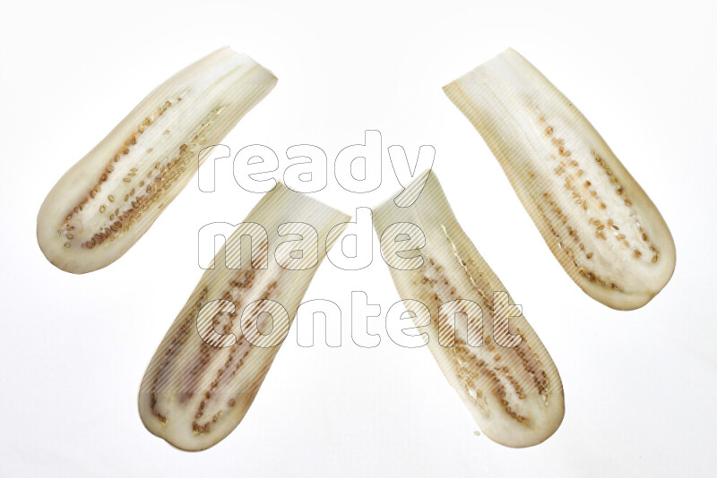 Eggplant slices on illuminated white background