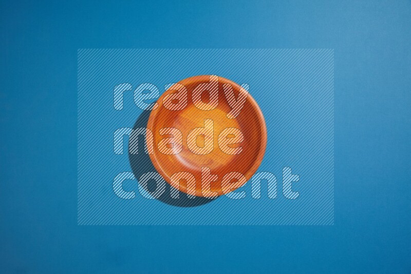 brown bowl on blue background