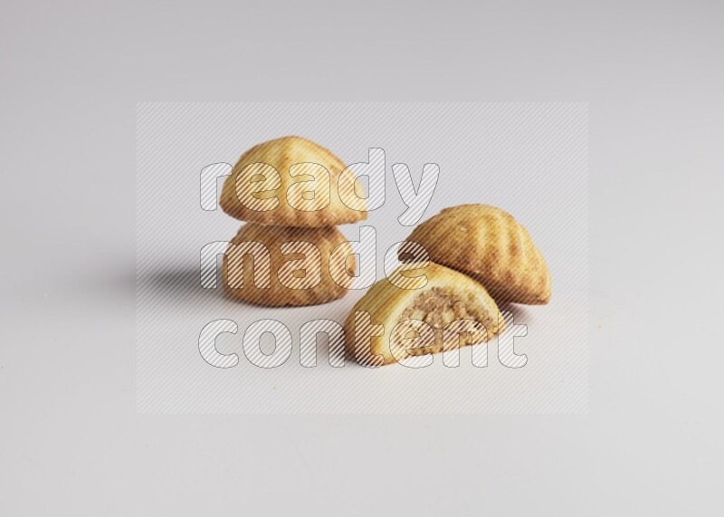 Four Pieces of Maamoul filled with walnut paste  one of them is cut direct on white background