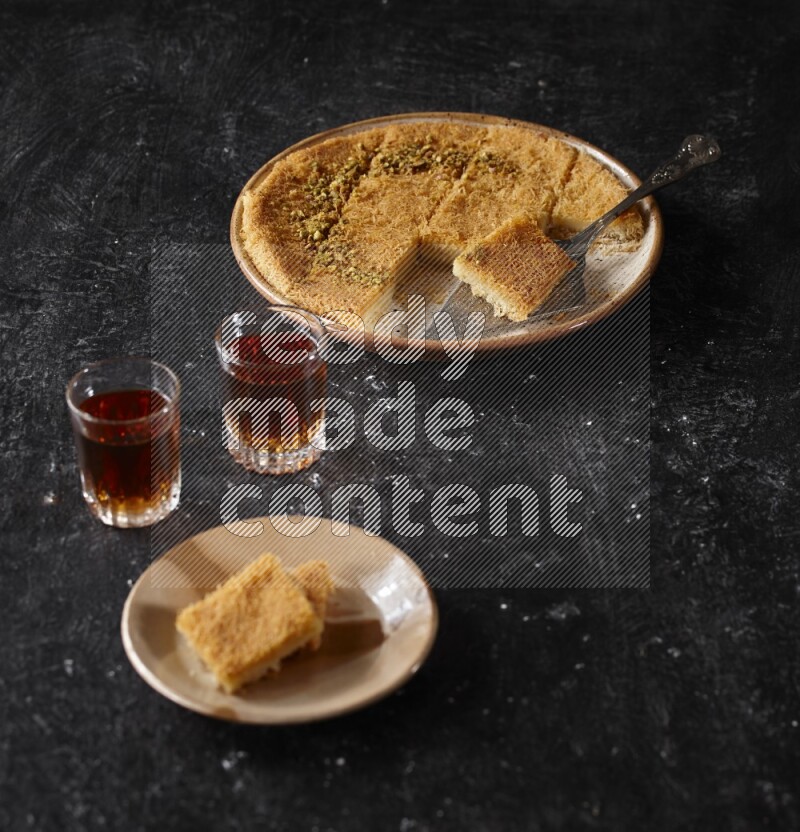 konafa with tea in a dark setup