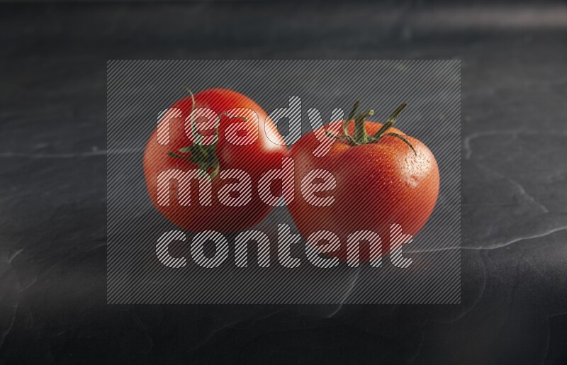 45 degree roma tomato on a textured black slate background