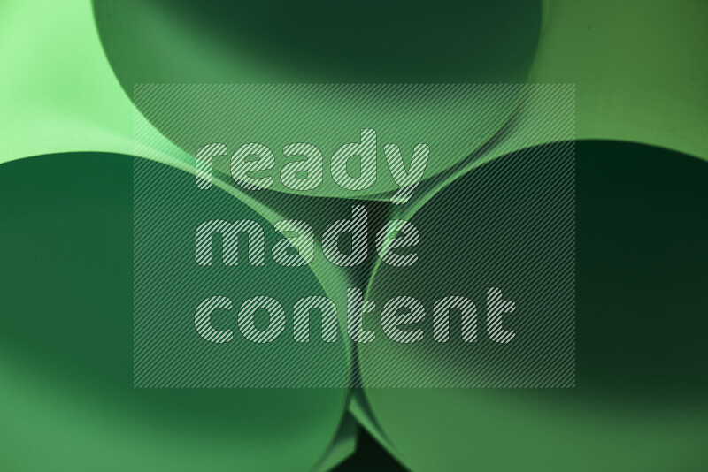 The image shows an abstract paper art with circular shapes in varying shades of green