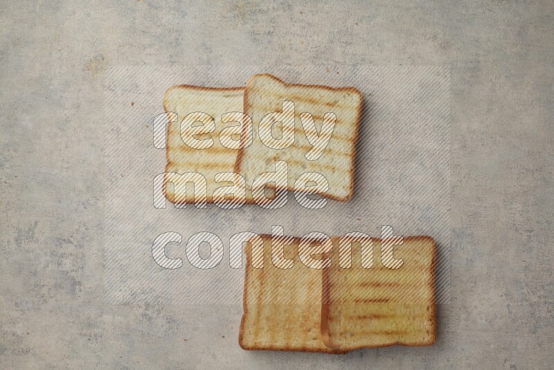Toasted white Toast slices on a light blue textured background