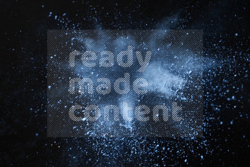 Blue powder explosion on black background