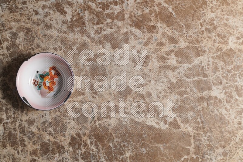 A vintage metal plate on beige marble background